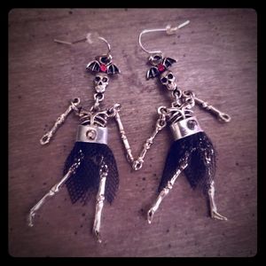 Dancing skeleton earrings in skirts